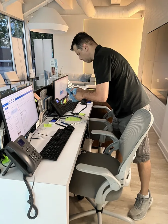 Crew member cleaning a reception desk in an Atlanta office